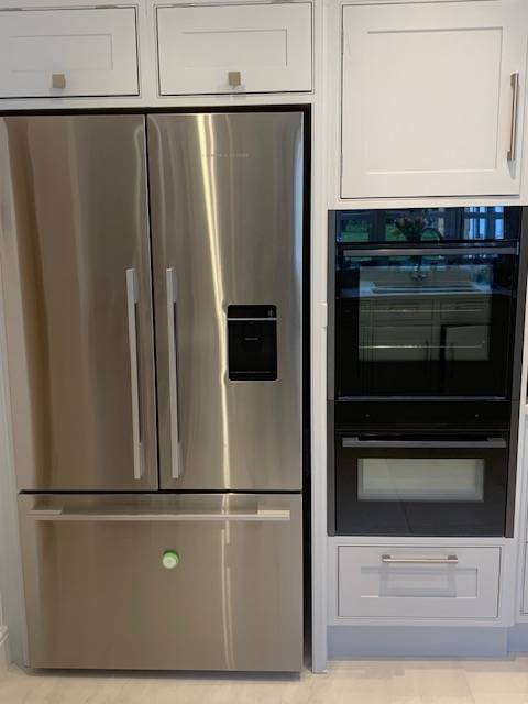 Tall fridge housing with tall ovens - Esher